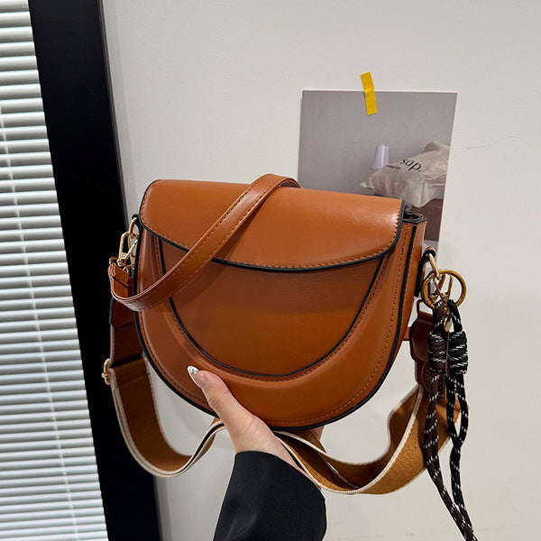 Curved Saddle Crossbody Bag with Dual Interchangeable Straps     ( Charm included )