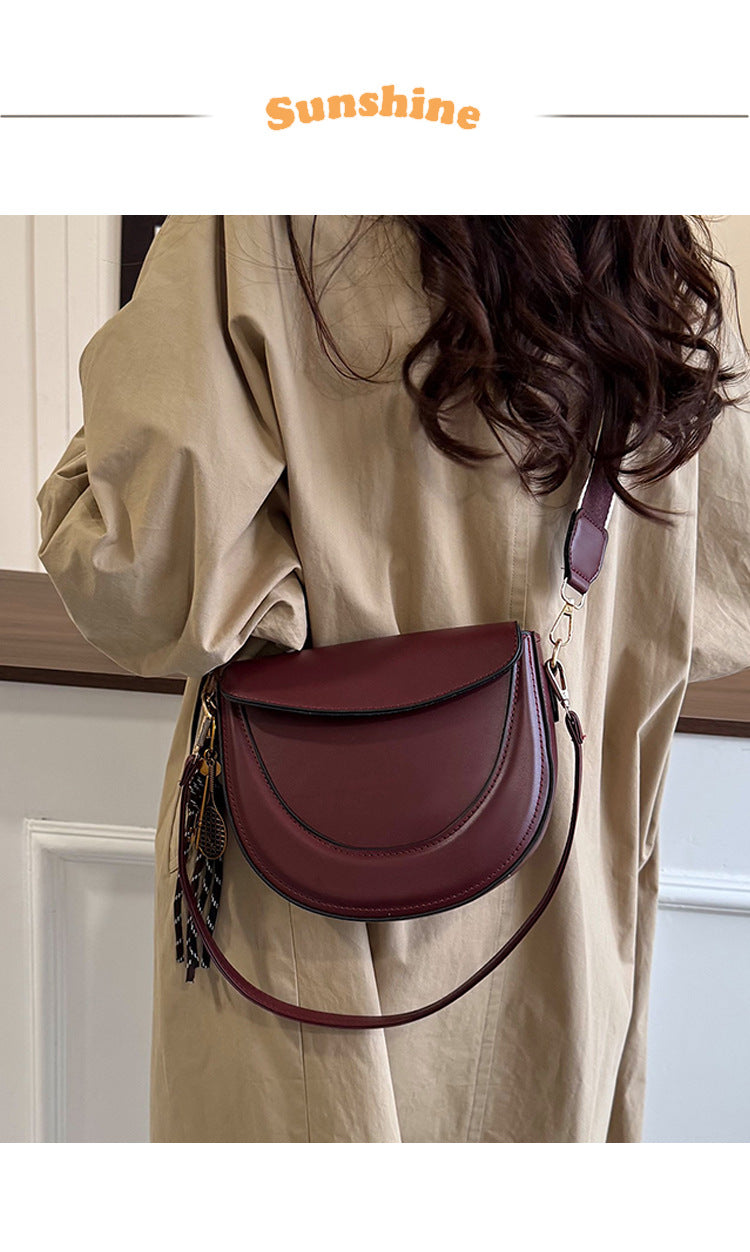 Curved Saddle Crossbody Bag with Dual Interchangeable Straps     ( Charm included )