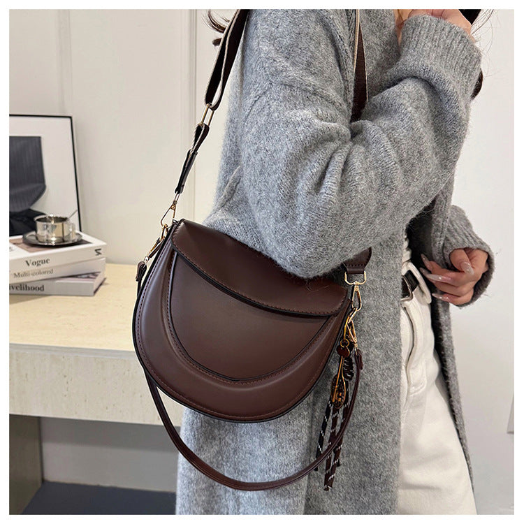 Curved Saddle Crossbody Bag with Dual Interchangeable Straps     ( Charm included )