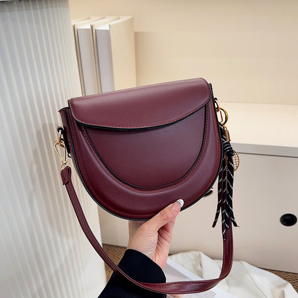 Curved Saddle Crossbody Bag with Dual Interchangeable Straps     ( Charm included )