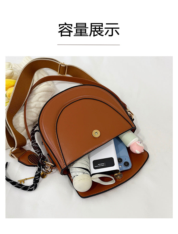 Curved Saddle Crossbody Bag with Dual Interchangeable Straps     ( Charm included )